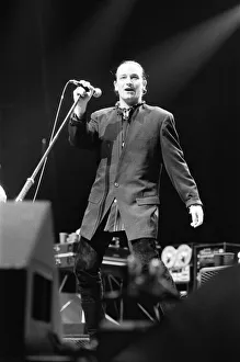 Rock group U2 in concert in USA. Bono singing on stage. May 1987 Rock group U2 in concert in USA. Bono singing on stage. May 1987