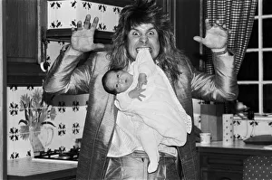 00155 Gallery: Rock star Ozzy Osbourne dangles two week old baby Jack from his teeth at his home