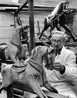 The Rocking-Horse Man, benign and twinkling, smoking his pipe The Rocking-Horse Man, benign and twinkling, smoking his pipe