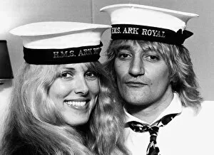 Rod Stewart singer with Alana Hamilton wearing Royal Navy HMS Ark Royal Caps during a