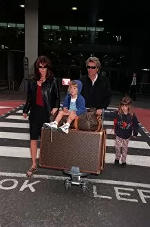 Images Dated 23rd April 1998: Rod Stewart Singer April 98 Arriving at Heathrow with his wife Rachel Hunter