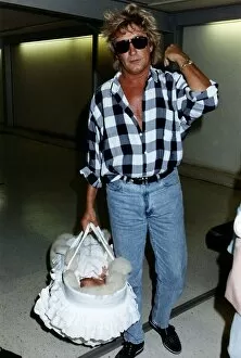 00054 Gallery: Rod Stewart Singer With baby daughter leaving Heathrow