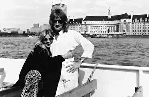 00054 Gallery: Rod Stewart singer with girlfriend Brit Ekland pose for a photograph during a boat trip