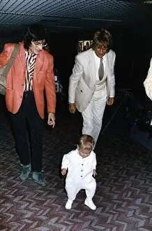 Images Dated 7th May 1993: Rod Stewart singer songwriter with Ronnie Wood escorts baby daughter Renee through