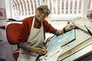 Ronald Carl Giles - Daily Express cartoonist at his drawing board in his studio Ronald Carl Giles - Daily Express cartoonist at his drawing board in his studio
