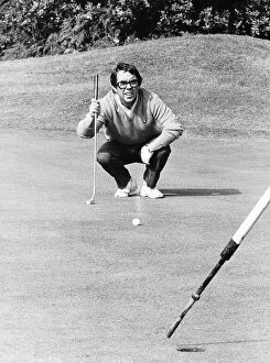 Images Dated 20th September 1974: Ronnie Corbett Comedian crouches down to eye up a putt during a golf match dbase