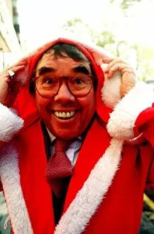 Ronnie Corbett comedian dresses as Father Christmas at a charity auction in London