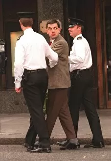 Images Dated 1st September 1996: Rowan Atkinson Actor as Mr Bean filming at Harrods - being arrested by policemen