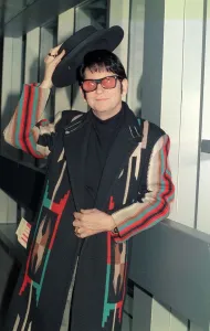 Images Dated 30th November 1988: Roy Orbison at Heathrow Airport November 1988 in multi coloured coat holding