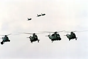 Four Royal Navy Sea King helicopters and three Sea Harriers in flight Four Royal Navy Sea King helicopters and three Sea Harriers in flight