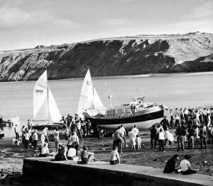 Runswick's new lifeboat, the Royal Thames is hauled up the beach watched by a large