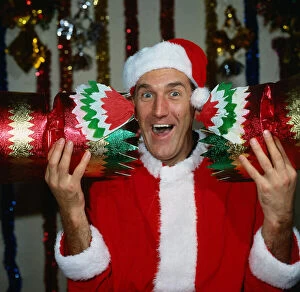 Russ Abbot comedian December 1986 dressed at Santa Claus holding Christmas cracker