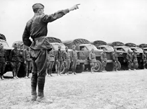 A Russian officer instructing his drivers as they take over Allied vehicles to control A Russian officer instructing his drivers as they take over Allied vehicles to control