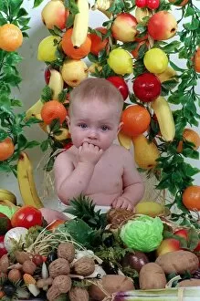 Images Dated 29th September 1992: Sam Stewart baby wearing nappy surrounded by fruit and vegetables September 1992 fingers