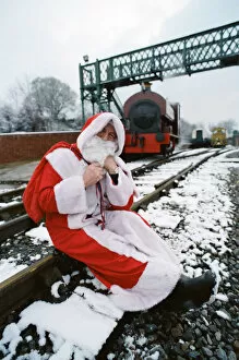 Images Dated 7th December 1995: Santa stopped in his tracks. Father Christmas sitting on railway tracks