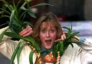 Images Dated 10th May 1993: Sarah Lancashire actress poking her head through a plant