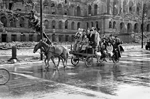 Scenes showing children being pulled along on a horse-drawn cart in the devastated German Scenes showing children being pulled along on a horse-drawn cart in the devastated German