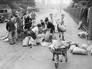Schoolboys from Yardley Primary School help council workmen fill sandbags just prior to Schoolboys from Yardley Primary School help council workmen fill sandbags just prior to