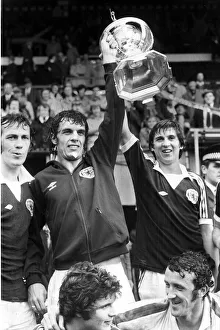 Scotland footballer Joe Jordan holds aloft the British International Football trophy with Scotland footballer Joe Jordan holds aloft the British International Football trophy with