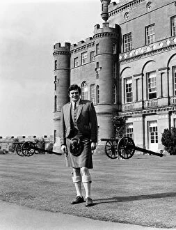 Cannons Collection: Scottish comedian Jimmy Logan standing outside Culzean castle wearing traditional