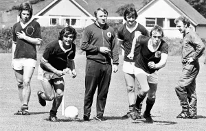 Scottish footballers Lou Macari and Colin Stein race each other as team boss Tommy Scottish footballers Lou Macari and Colin Stein race each other as team boss Tommy