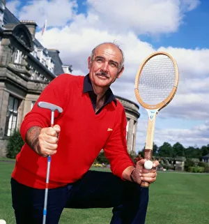 Sean Connery holding tennis raquet and golf club August 1981 Sean Connery holding tennis raquet and golf club August 1981