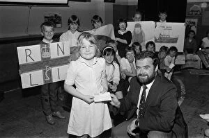Images Dated 14th October 1986: Seven-year old Adele Brooke presents a £588 cheque from Dalton Junior School to Mr