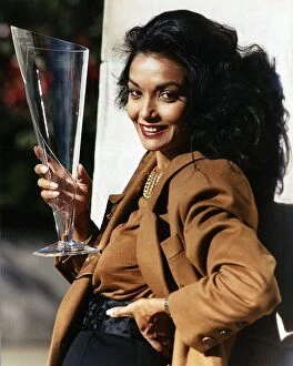 Shakira Caine wife of actor Michael Caine holding a long glass