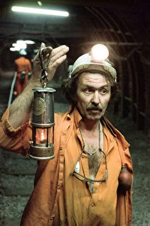 The last shift at Cotgrave Colliery, one of the last miners underground holds a Davy lamp