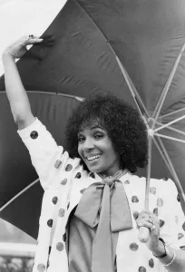 Shirley Bassey smiling under umbrella - September 1982 02/09/1982 Shirley Bassey smiling under umbrella - September 1982 02/09/1982