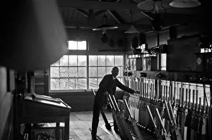 Signalman working in an unknown signal box on the Woking to Waterloo line. November 1938 Signalman working in an unknown signal box on the Woking to Waterloo line. November 1938