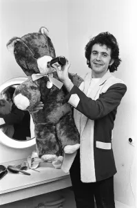 Singer and Actor David Essex poses with a teddy bear sent to him by a fan before going Singer and Actor David Essex poses with a teddy bear sent to him by a fan before going