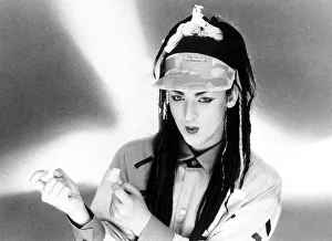 Singer Boy George with hair extensions wearing a cap with his name on it Singer Boy George with hair extensions wearing a cap with his name on it