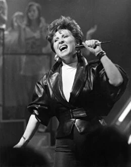 Images Dated 9th August 1986: Singer Lulu dressed in leather jacket with microphone, on stage singing