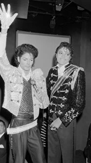 Images Dated 28th March 1985: Singer Michael Jackson looking at a waxwork model of himself on display at madame