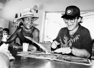Images Dated 24th October 1982: Singer and songwriter Elton John with his co-star lyricist Bernie Taupin seems happy once