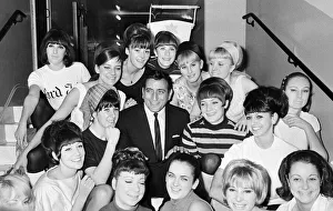 Singer Tony Bennett surrounded by chorus girls. 7th November 1965 Singer Tony Bennett surrounded by chorus girls. 7th November 1965