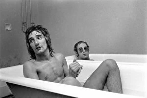 Music Posters: Singers Elton John and Rod Stewart having bath at Watford football ground
