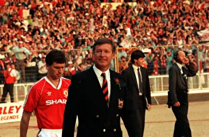 Sir Alex Ferguson leads the team out, followed by Bryan Robson Sir Alex Ferguson leads the team out, followed by Bryan Robson