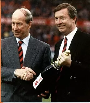 Sir Bobby Charlton shaking hands with Manchester United manager Alex Ferguson after