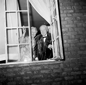 00489 Gallery: Sir Winston Churchill and Lady Churchill look from the window of his London home in Hyde