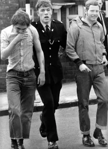 Two skinheads are led away by a policeman on 9th May 1971 Two skinheads are led away by a policeman on 9th May 1971