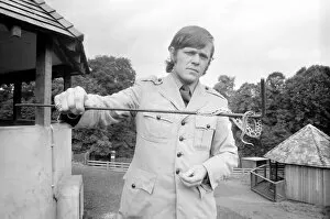 Images Dated 19th July 1970: Snakes: Watched warily by his wife Patricia, snake handler Peter Waters goes back to work