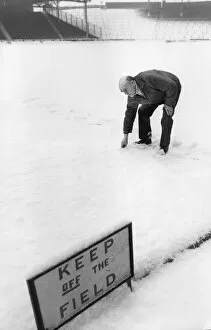 Snow bound Ibrox Park head groundsman Dave Marshall surveys the pitch after heavy snow