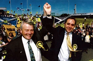 Images Dated 4th June 1994: SNP leader Alex Salmond lifts Allan Macartneys arm after his stunning victory