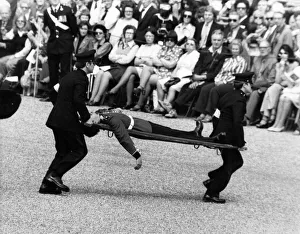 A soldier of the Scots Guard is stretchered off the parade ground during the Trooping of A soldier of the Scots Guard is stretchered off the parade ground during the Trooping of