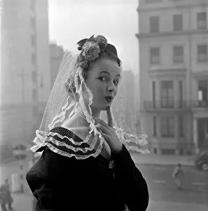 Spanish Mantilla lace held to the head by a real Carnation and is Modelled by Jill Howard Spanish Mantilla lace held to the head by a real Carnation and is Modelled by Jill Howard