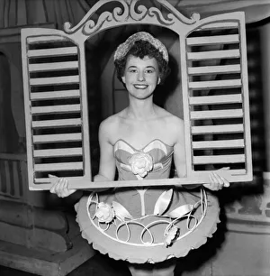 And through the square window. Chorus girl holding window frame And through the square window. Chorus girl holding window frame