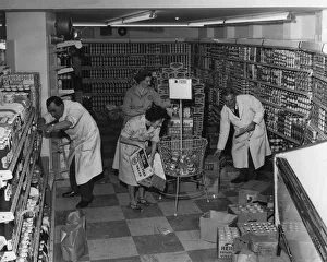 Staff busy stocking shelves at Batemans, The Welsh Grocers, Supermarket, Cardiff, Wales Staff busy stocking shelves at Batemans, The Welsh Grocers, Supermarket, Cardiff, Wales