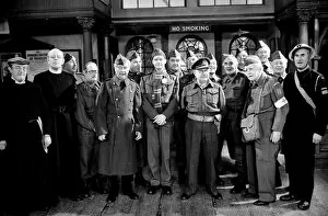 Stars of the popular wartime comedy television programme Dads Army toast pose for a group